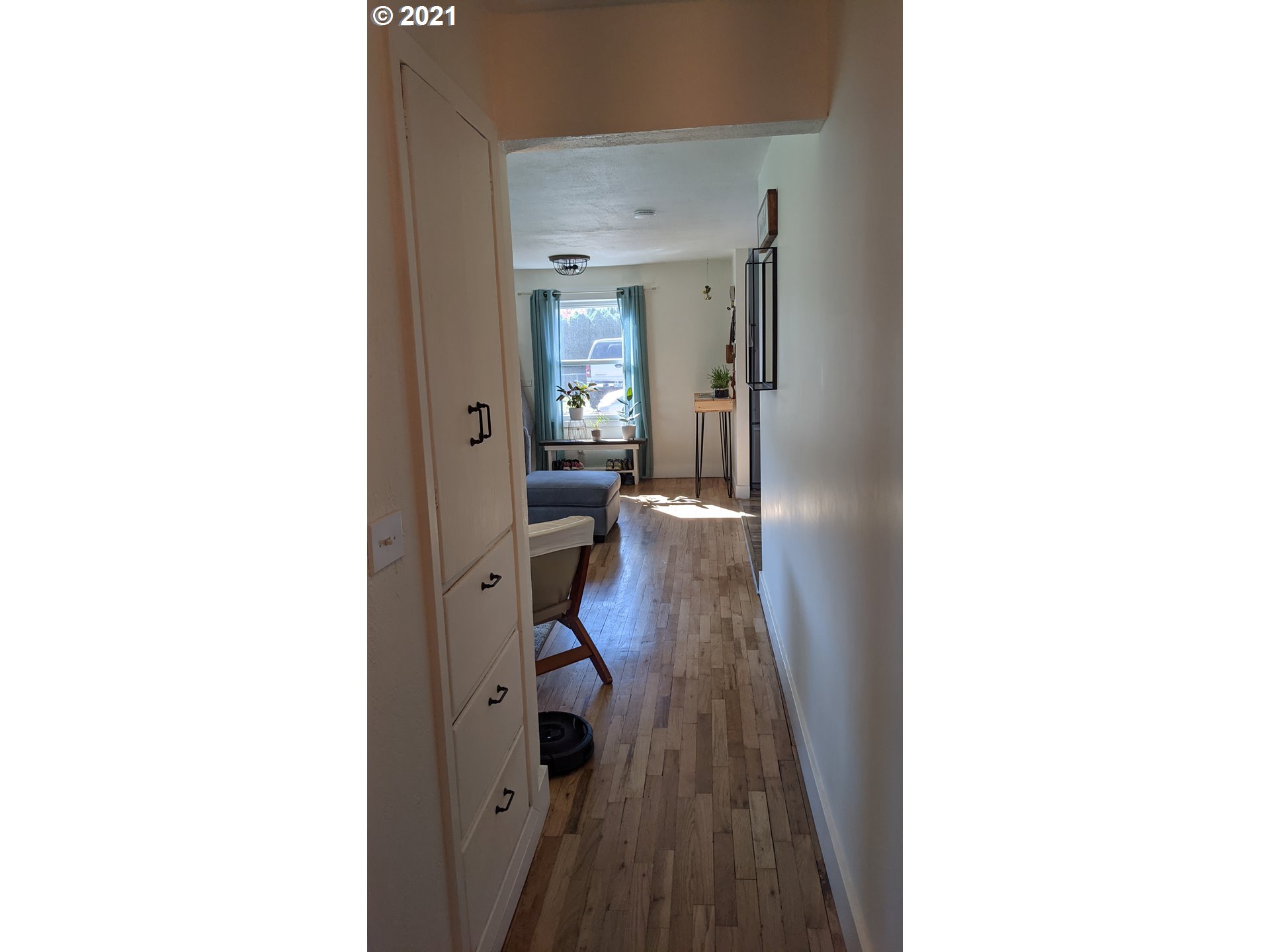 1672 Tucker Road Hood River, OR 97031 - Photo 8 of 15 a view of a hallway with a white walls and wooden floor
