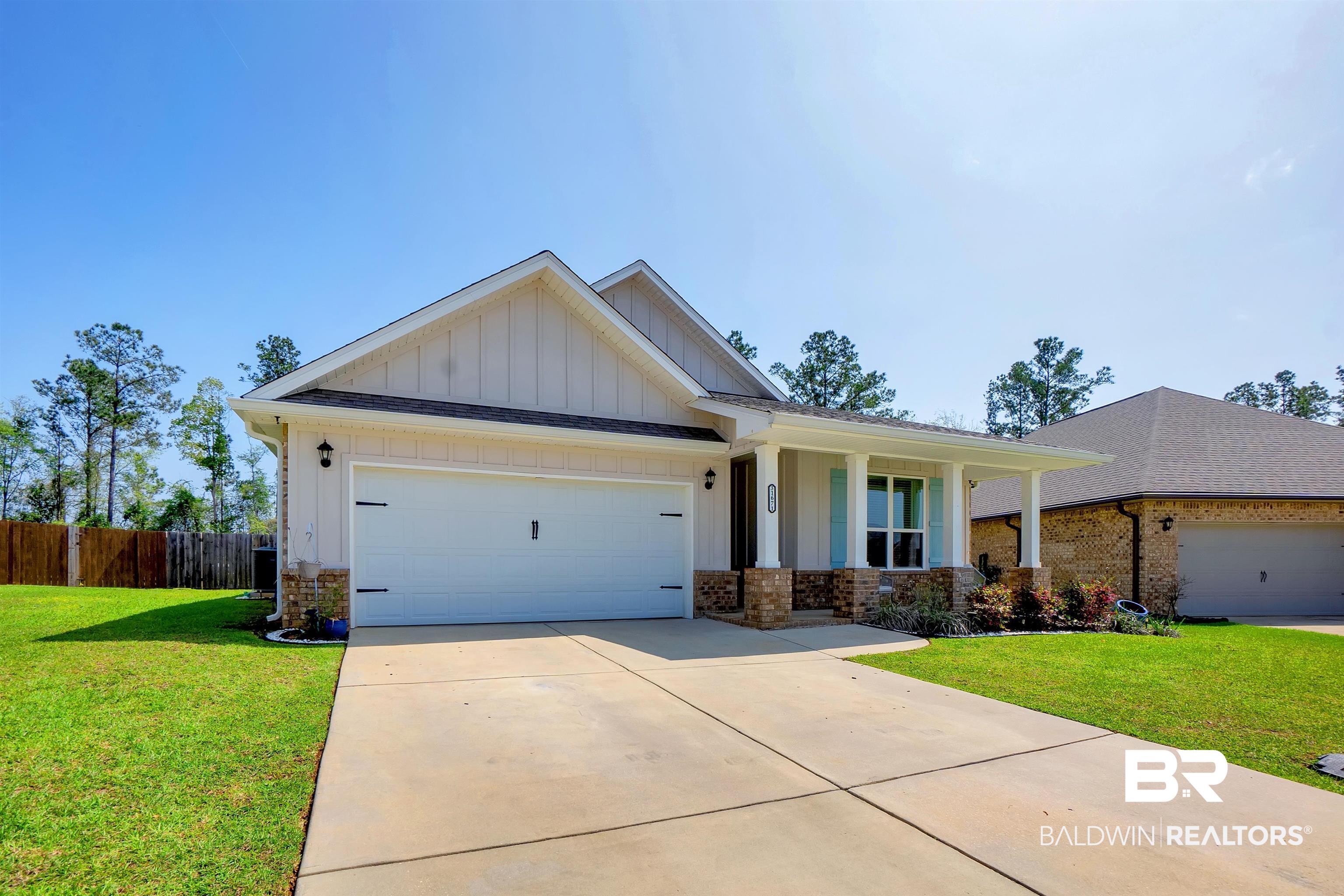 31671 Memphis Loop Daphne, AL 36527 - Photo 2 of 51 Craftsman-style home with driveway, a front yard, fence, board and batten siding, and a garage