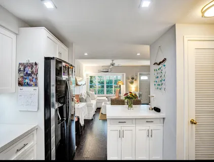 a view of a kitchen with refrigerator and workspace