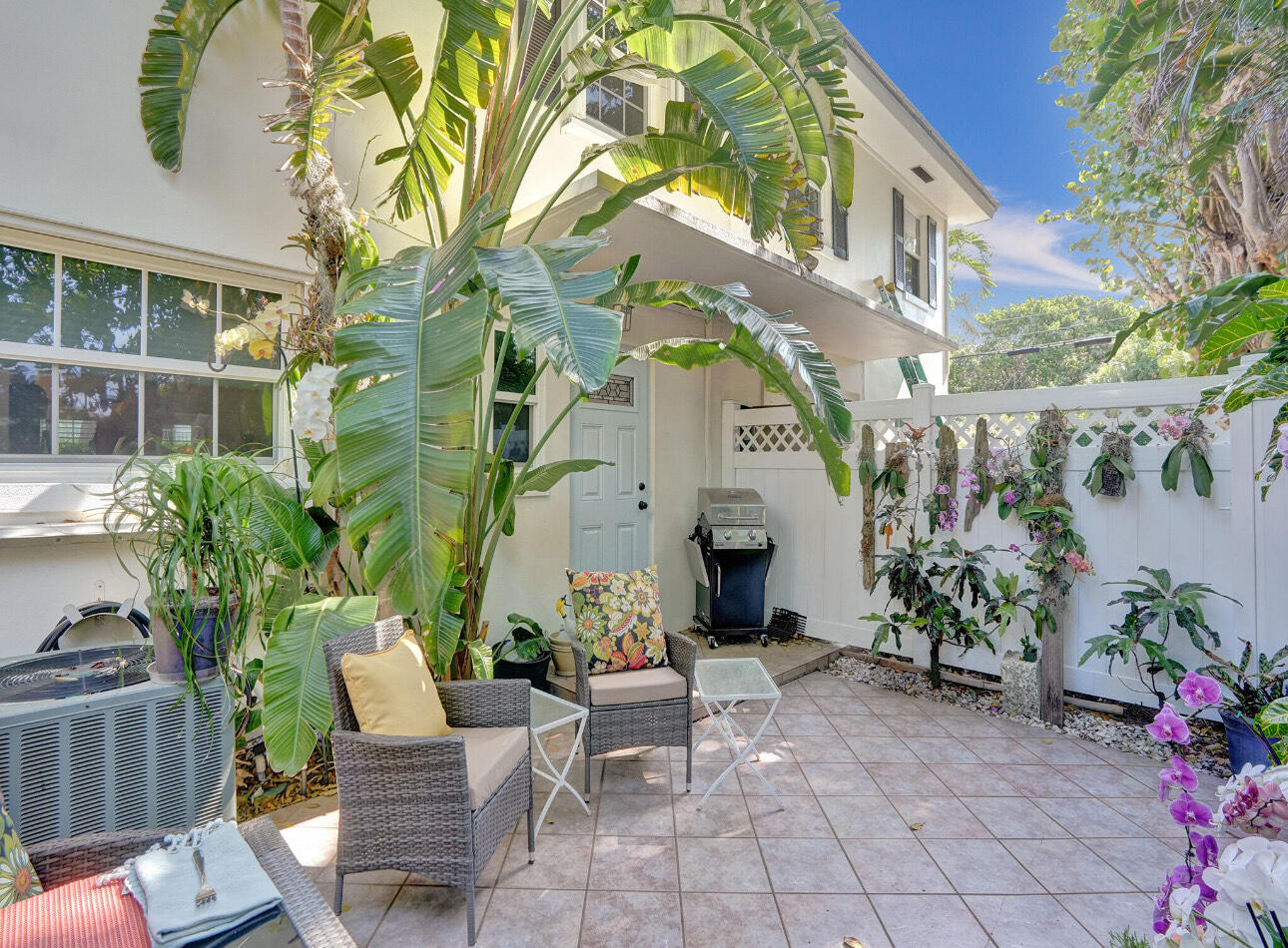6590 North Ocean Boulevard, Unit 9 Ocean Ridge, FL 33435 - Photo 17 of 18 a view of a patio with couches table and chairs and potted plants