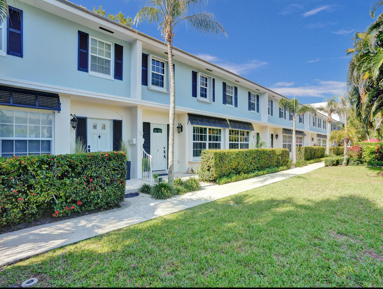 6590 North Ocean Boulevard, Unit 9 Ocean Ridge, FL 33435 - Photo 2 of 18 a front view of a building with a garden