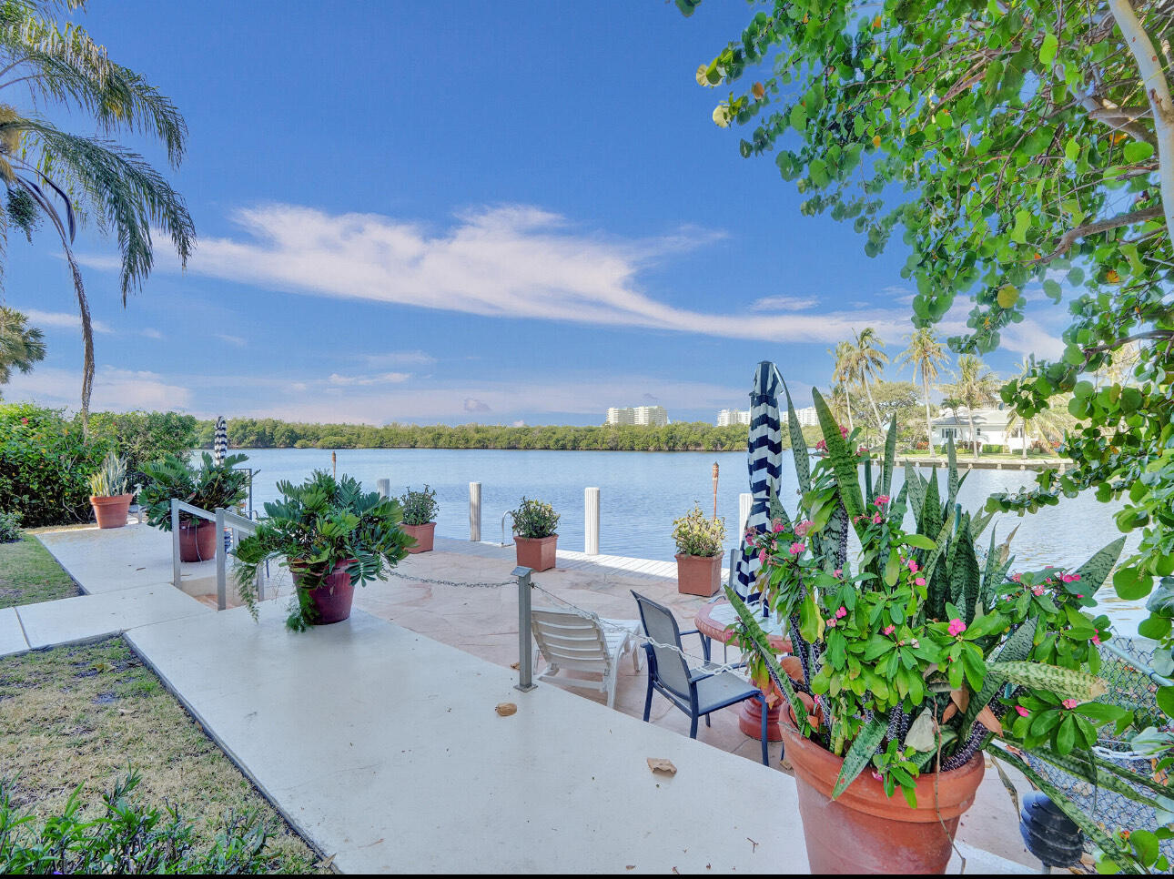 6590 North Ocean Boulevard, Unit 9 Ocean Ridge, FL 33435 - Photo 4 of 18 a view of a terrace with chairs and a potted plant