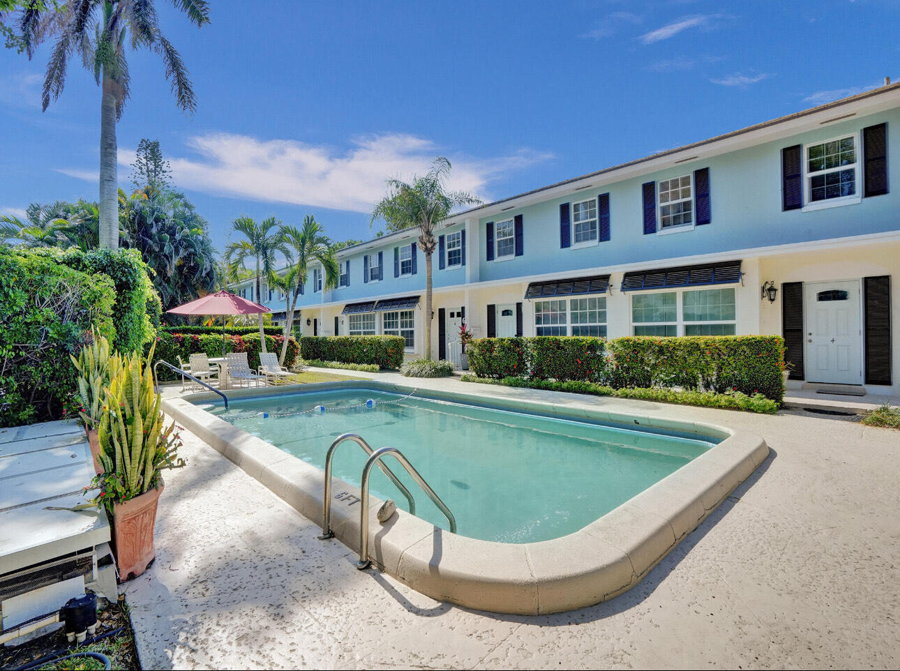 6590 North Ocean Boulevard, Unit 9 Ocean Ridge, FL 33435 - Photo 5 of 18 a view of a swimming pool with a lounge chairs