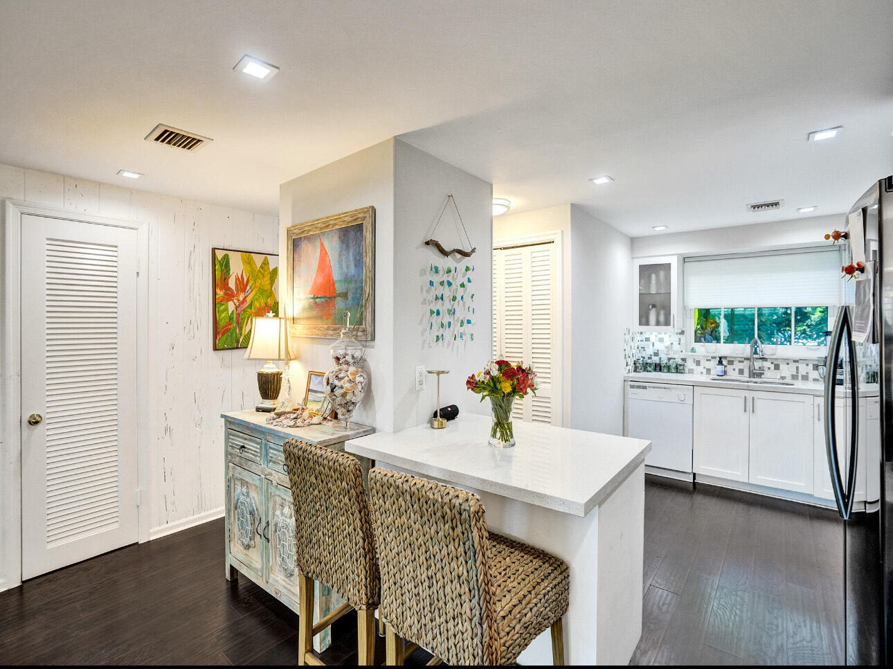 6590 North Ocean Boulevard, Unit 9 Ocean Ridge, FL 33435 - Photo 7 of 18 a kitchen with a sink cabinets and dining table