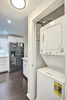 a view of washer and dryer with wooden floor