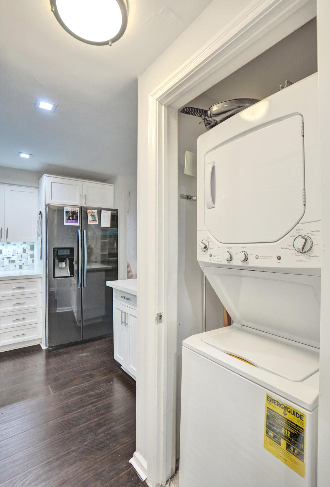 6590 North Ocean Boulevard, Unit 9 Ocean Ridge, FL 33435 - Photo 9 of 18 a view of washer and dryer with wooden floor