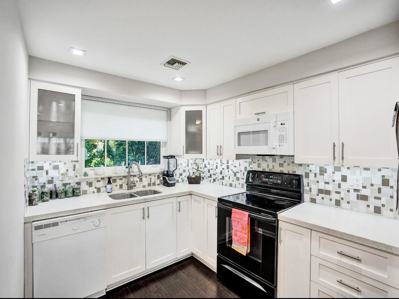 6590 North Ocean Boulevard, Unit 9 Ocean Ridge, FL 33435 - Photo 10 of 18 a kitchen with a stove sink and cabinets