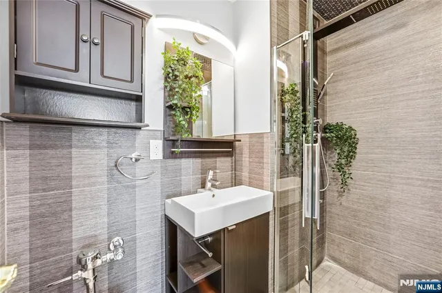 a bathroom with a sink a mirror and a shower