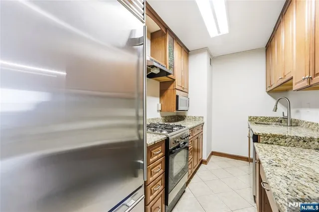a kitchen with stainless steel appliances granite countertop a stove and a sink