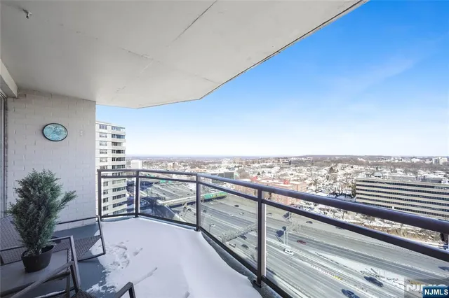 a view of a terrace with wooden floor and city view