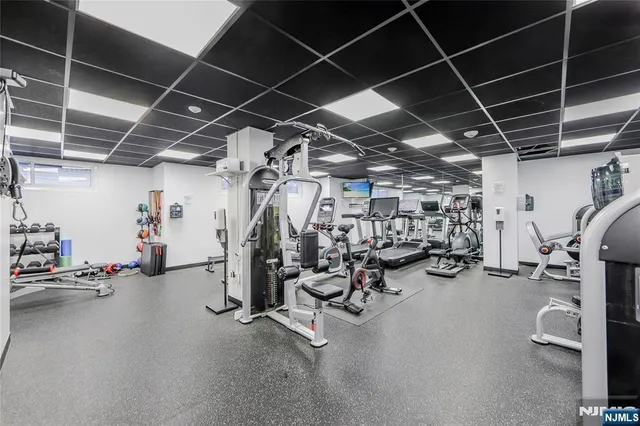 a view of empty room with gym equipment