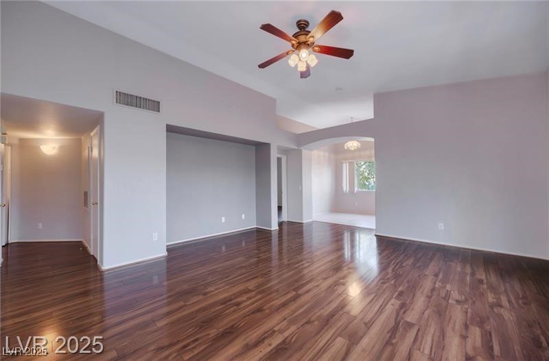 2152 Turquoise Ridge Street, Unit 202 Las Vegas, NV 89117 - Photo 2 of 23 Spare room featuring dark wood-style floors, arched walkways, and a ceiling fan