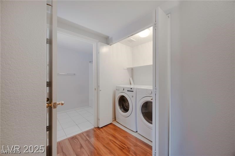 2152 Turquoise Ridge Street, Unit 202 Las Vegas, NV 89117 - Photo 6 of 23 Washroom featuring light wood-style floors and washer and dryer