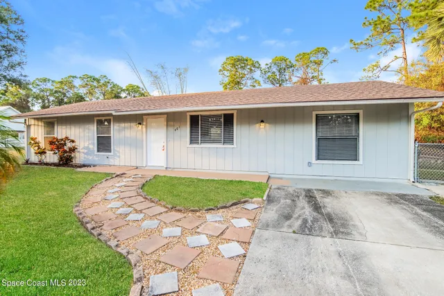 a view of a backyard with a garden and plants