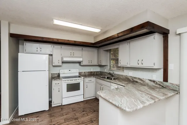 a kitchen with a stove a sink and a refrigerator