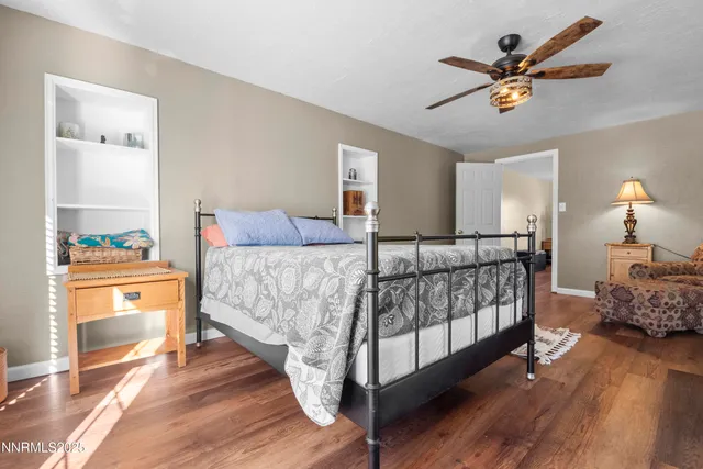 a living room with a bed furniture and a flat tv screen