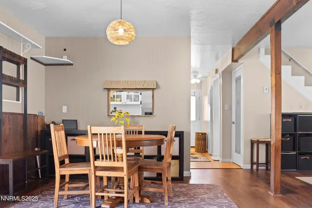 a dining room with furniture a chandelier and wooden floor