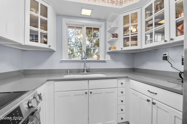 a kitchen with stainless steel appliances granite countertop a sink a stove and a refrigerator