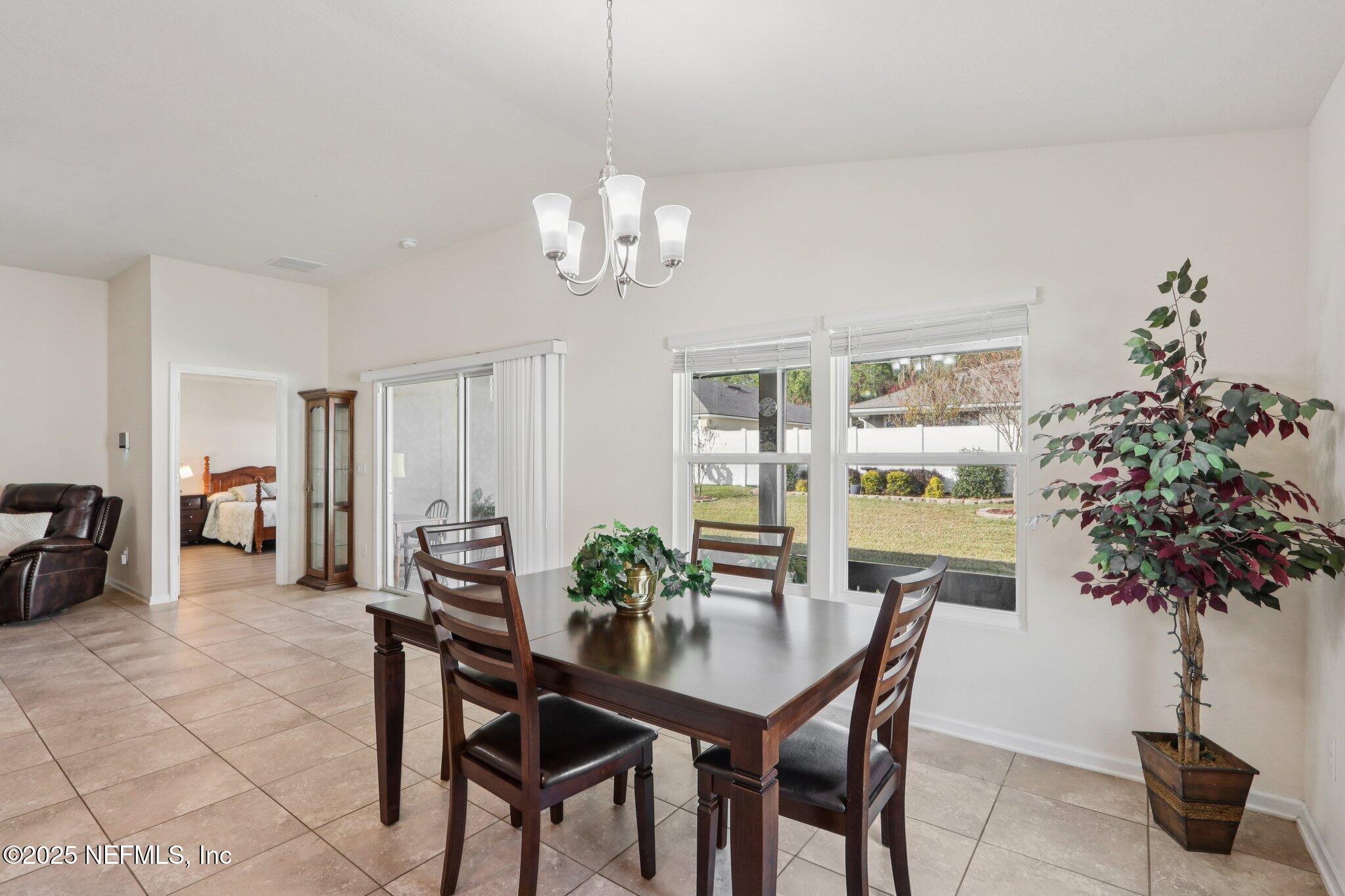 4100 Spring Creek Lane Middleburg, FL 32068 - Photo 11 of 58 a view of a dining room with furniture window and wooden floor