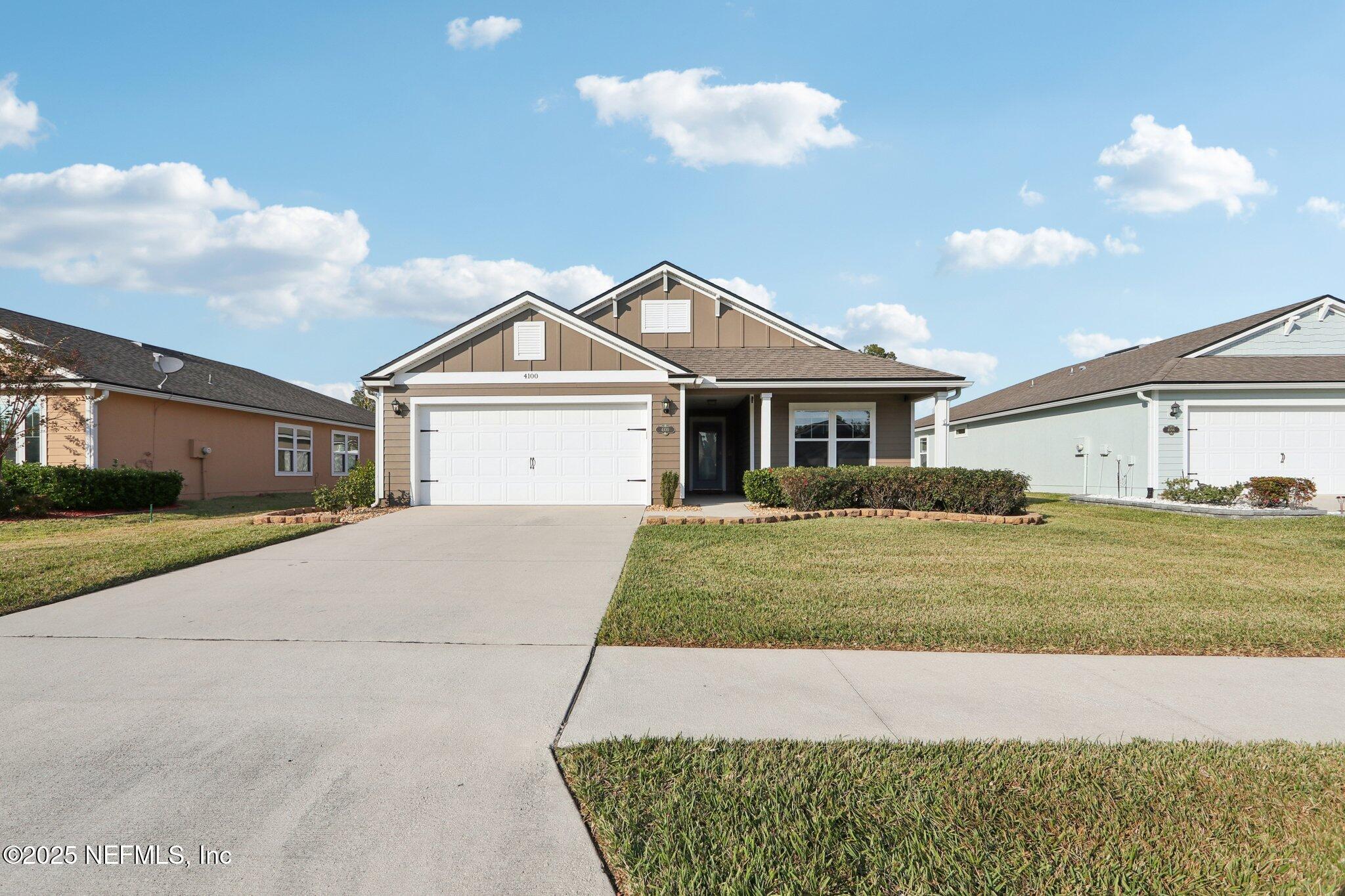 4100 Spring Creek Lane Middleburg, FL 32068 - Photo 2 of 58 a front view of a house with a yard and garage