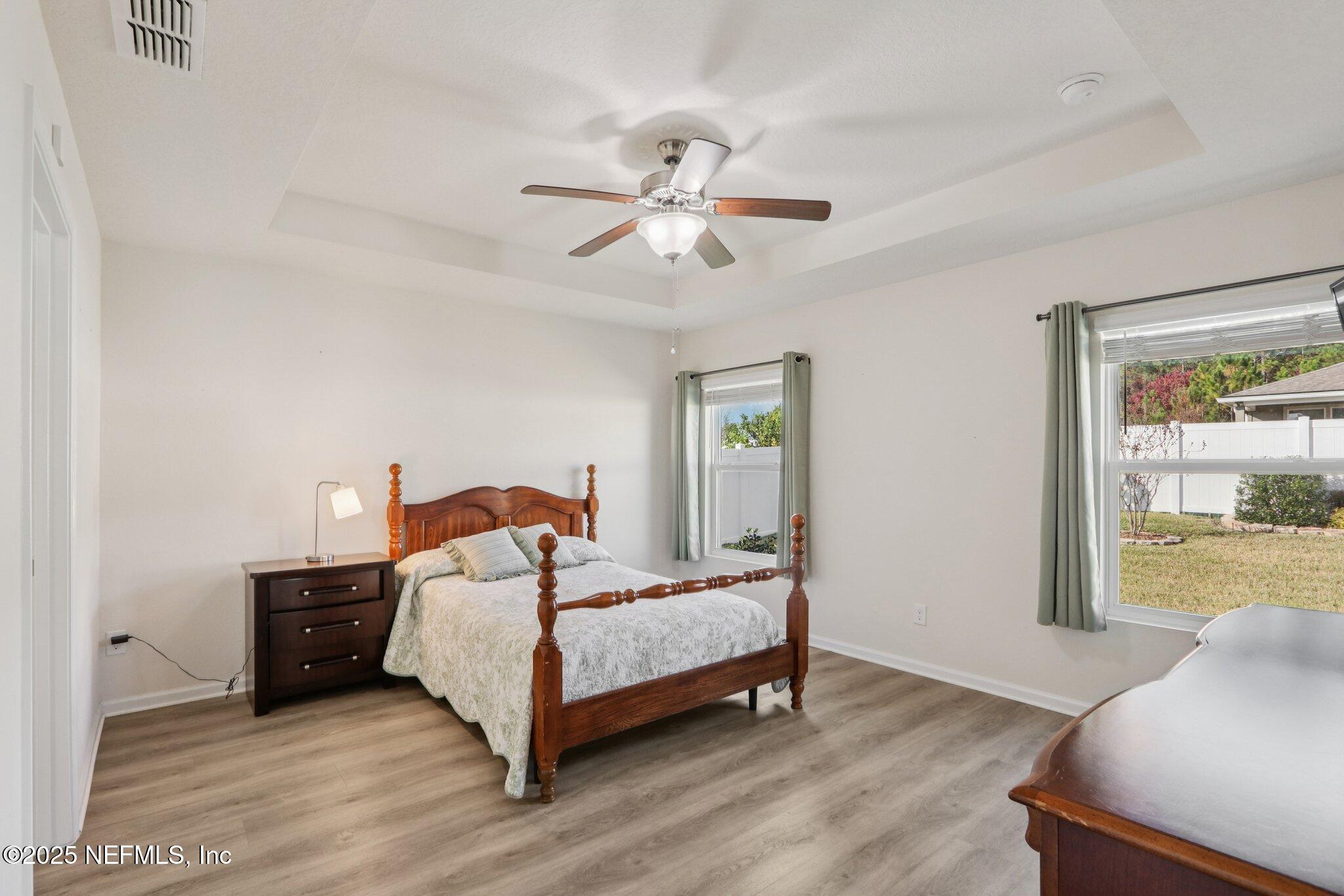 4100 Spring Creek Lane Middleburg, FL 32068 - Photo 22 of 58 a bedroom with a bed and wooden floor
