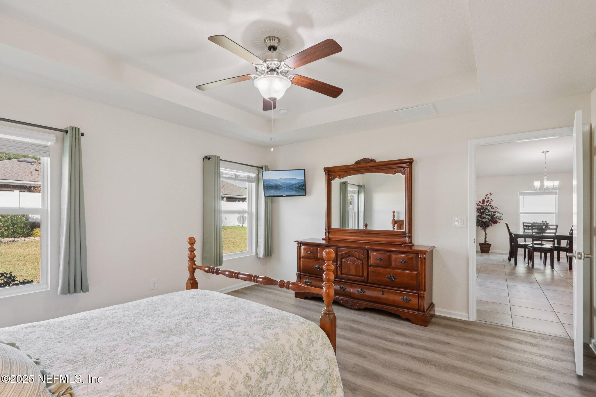 4100 Spring Creek Lane Middleburg, FL 32068 - Photo 23 of 58 a bedroom with a bed and wooden floor