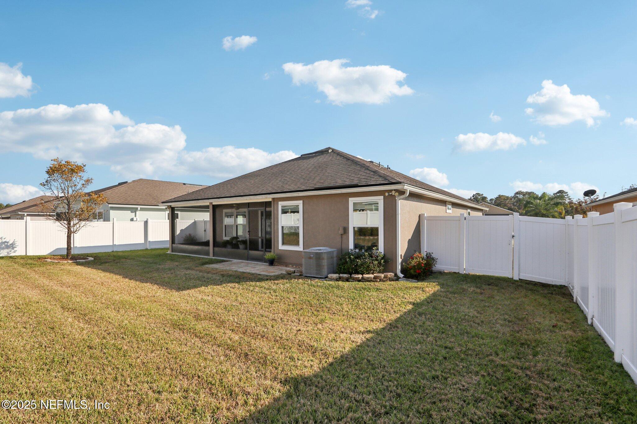 4100 Spring Creek Lane Middleburg, FL 32068 - Photo 30 of 58 a front view of a house with a yard and garage