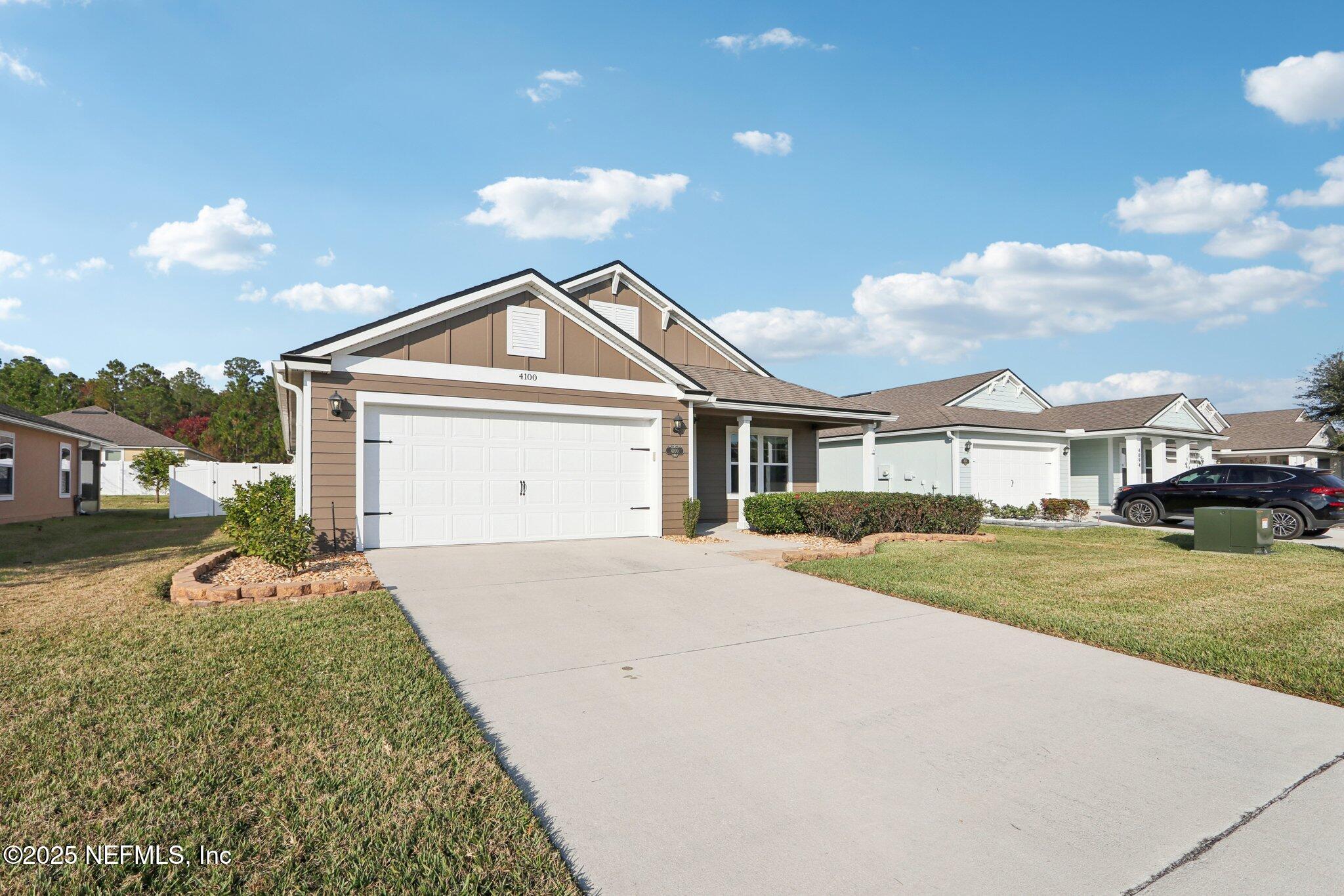 4100 Spring Creek Lane Middleburg, FL 32068 - Photo 3 of 58 a front view of a house with a yard