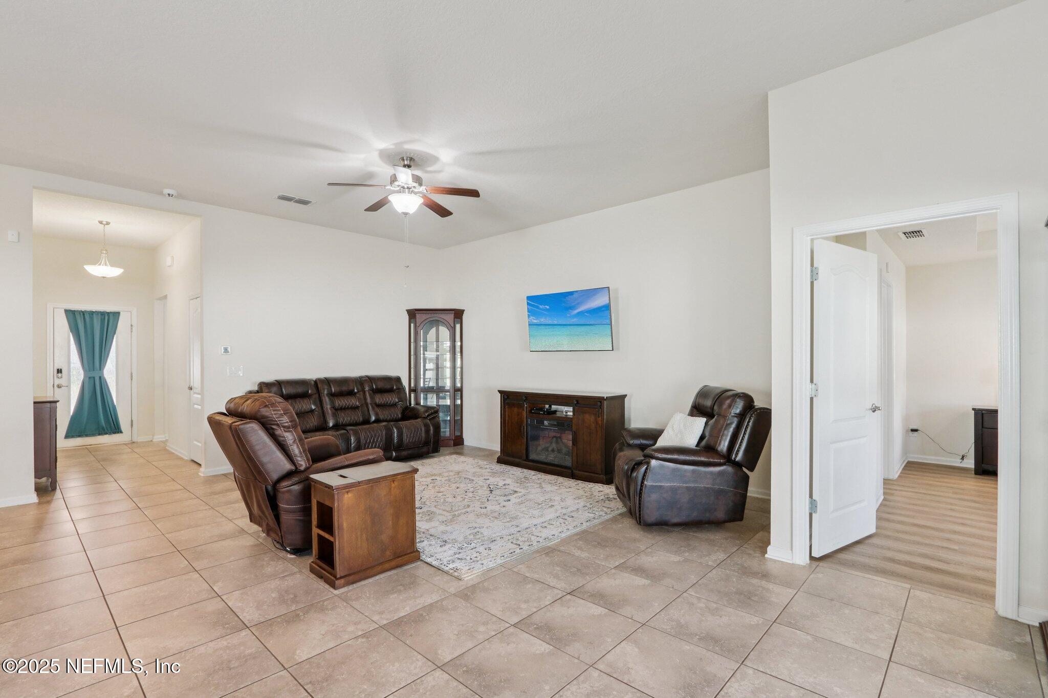 4100 Spring Creek Lane Middleburg, FL 32068 - Photo 7 of 58 a living room with furniture and a fireplace