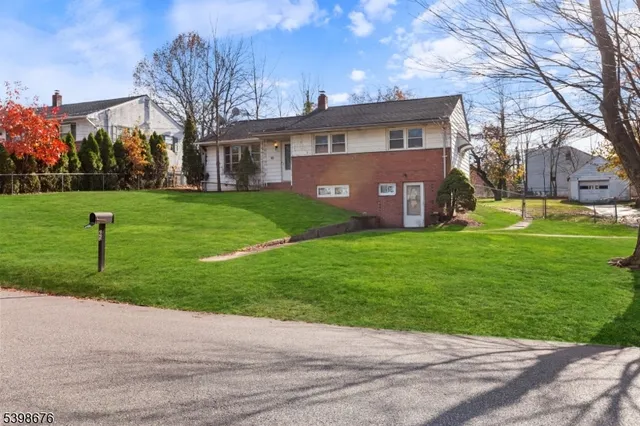 a front view of house with yard and green space