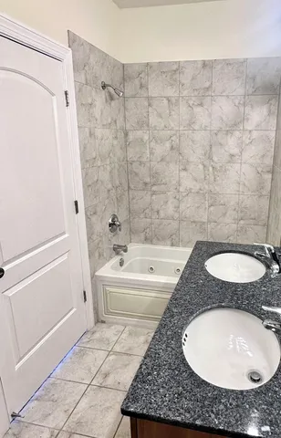 a bath tub sitting next to a white sink