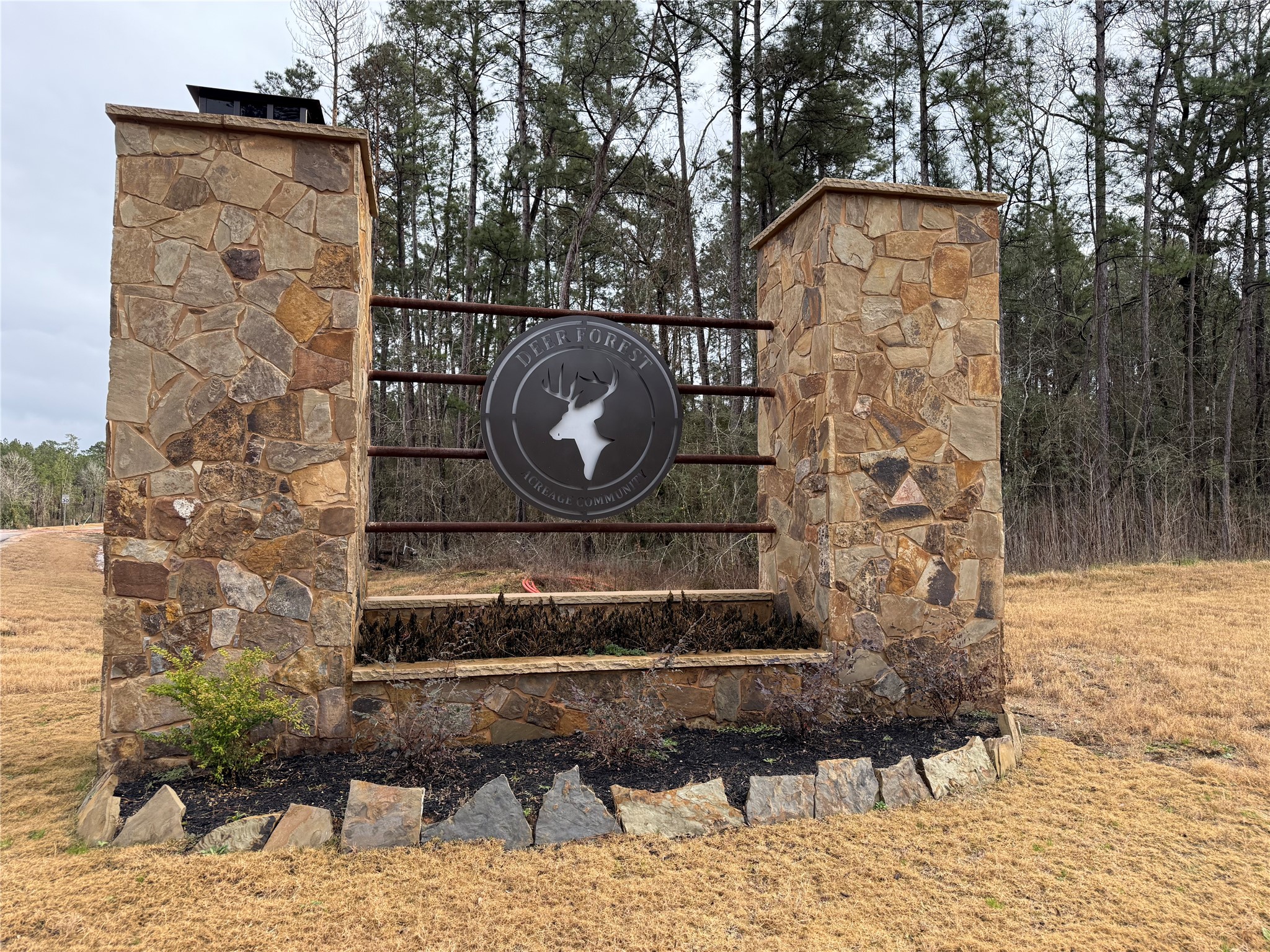 122 Signal Road Willis, TX 77378 - Photo 8 of 8 Welcome to Deer Forest! A beautifully designed stone entryway marks the entrance to this exclusive acreage community, offering privacy, natural beauty, and the perfect place to build your home