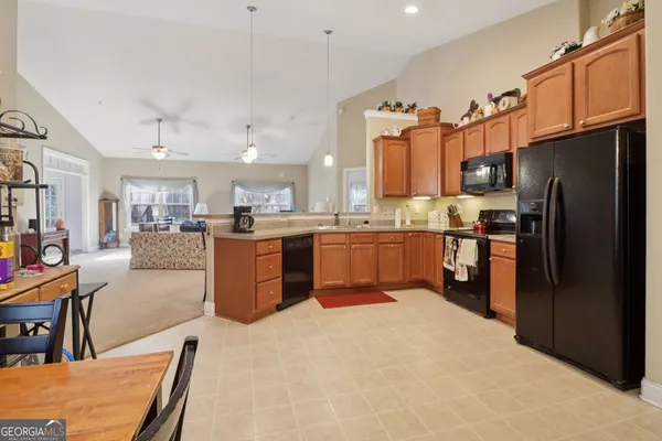 a kitchen with stainless steel appliances granite countertop a refrigerator and a stove