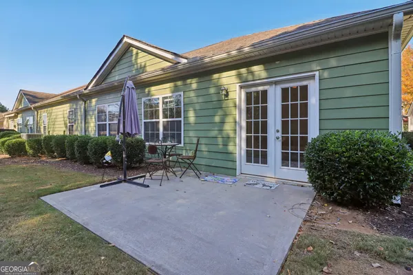 a view of a house with backyard and sitting area