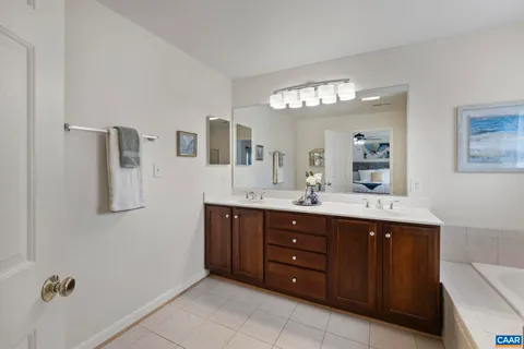 a spacious bedroom with a bed and a chandelier