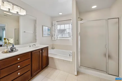 a spacious bathroom with a granite countertop sink a mirror and a