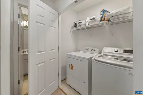 a bathroom with a sink vanity mirror and toilet