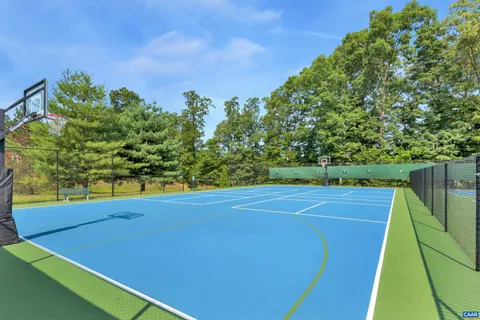 a tennis court with trees in the background