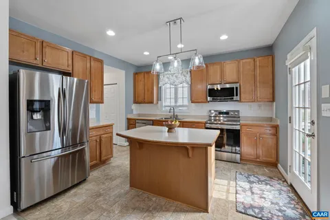 a kitchen with stainless steel appliances a refrigerator stove and microwave