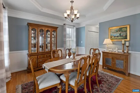 a view of a a dining room with furniture window and wooden floor