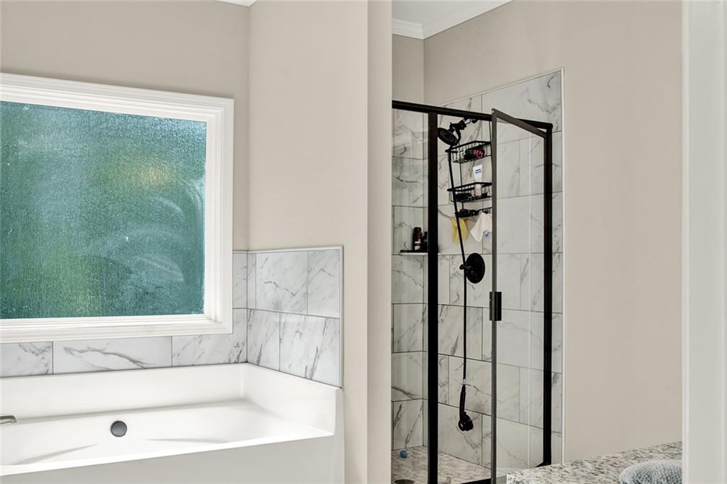 407 Corinth Church Road Winder, GA 30680 - Photo 41 of 66 a bathroom with a bathtub and a shower
