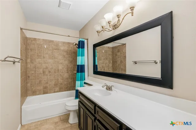 a bathroom with a sink a toilet and bathtub