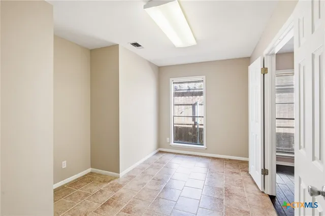 a view of an empty room with a window