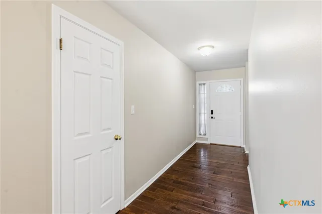 a view of hallway with wooden floor