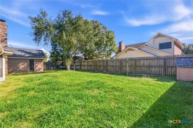 a front view of a house with patio and garden