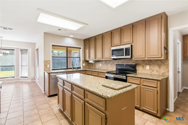 a kitchen with a stove a sink and a microwave