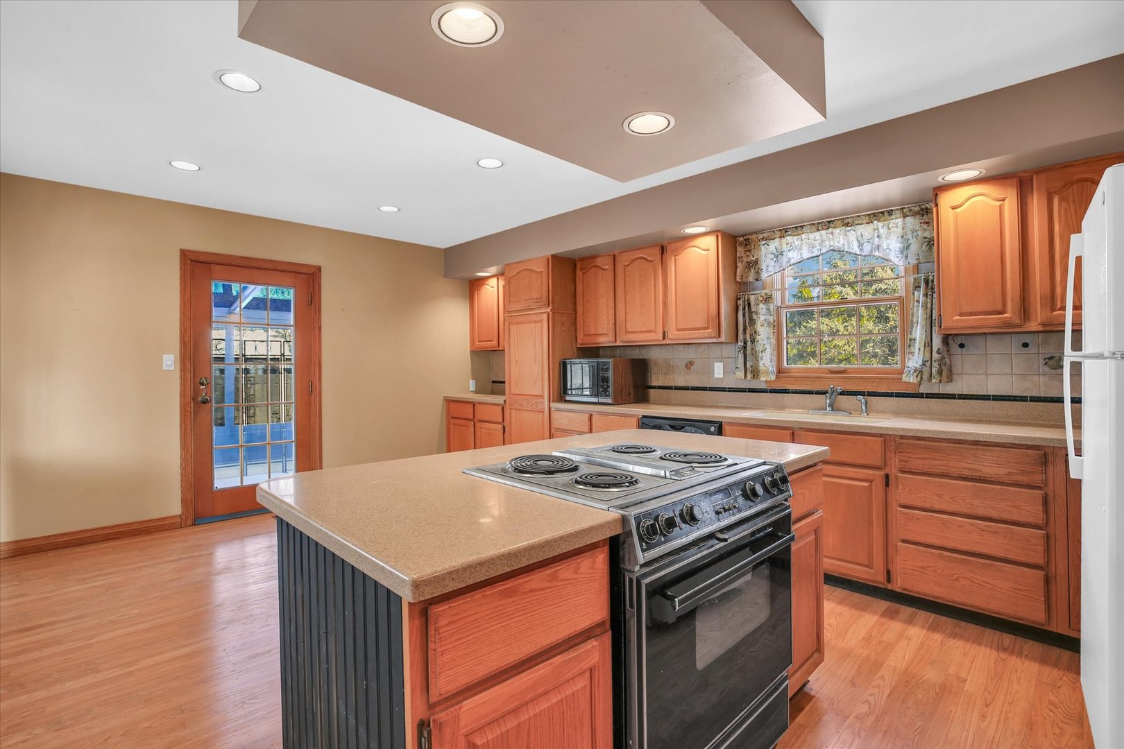 2002 O O Donnell Drive Champaign, IL 61821 - Photo 17 of 45 a kitchen with a stove a sink a microwave and wooden floor