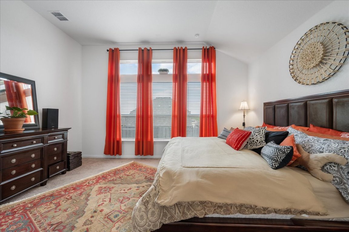 181 Durian Loop Buda, TX 78610 - Photo 14 of 22 a bedroom with a bed and wooden floor