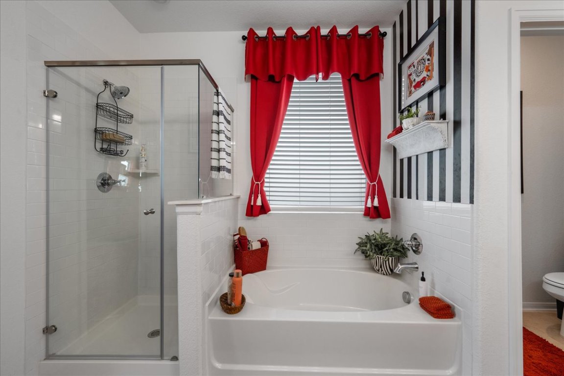 181 Durian Loop Buda, TX 78610 - Photo 15 of 22 a bathroom with a bathtub and shower