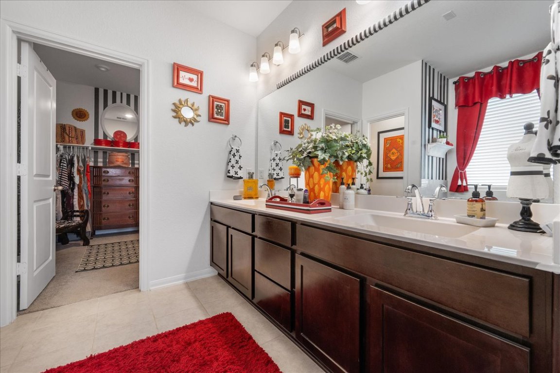 181 Durian Loop Buda, TX 78610 - Photo 16 of 22 a kitchen with a sink and a refrigerator